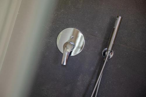 a metal door knob on the floor in a bathroom at Paverno Suites in Marano di Valpolicella