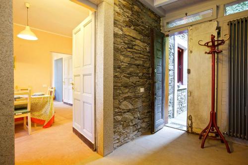 an open door to a room with a stone wall at Villa Scagliola in Verbania