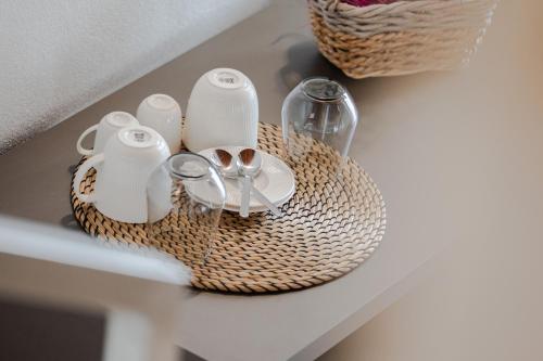 a wicker basket with utensils on a table at Paverno Suites in Marano di Valpolicella