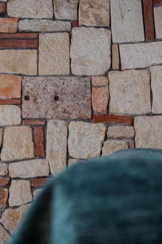 a stone wall of a building at Paverno Suites in Marano di Valpolicella