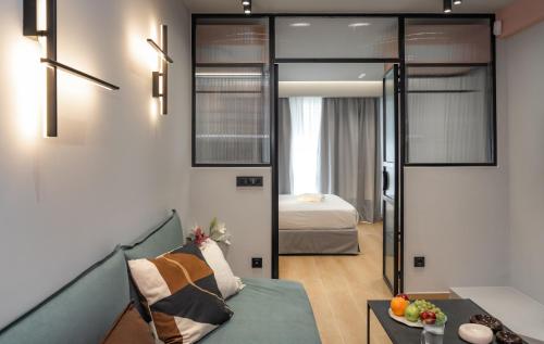 a living room with a couch and a bed at Dion Luxury Suites in Athens