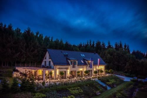 a house with solar panels on the roof at night at Osada Prado in Michałkowa