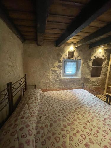 a bedroom with a bed in a room with a window at ALBERGO DIFFUSO ORNICA NEL CUORE in Ornica