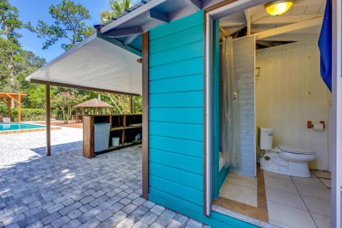 a blue house with a toilet and a pavilion at 1 Mi to UF Campus Group Retreat with Outdoor Oasis in Gainesville