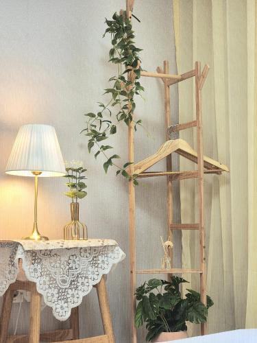 a wooden ladder next to a table with a lamp at Gonghangdong Every moment in Seoul