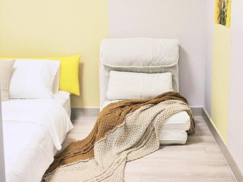 a bedroom with two beds and a blanket on the floor at Gonghangdong Every moment in Seoul