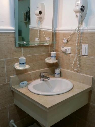 a bathroom sink with a hair dryer and a mirror at Appartamento Vista Mare in Bayahibe