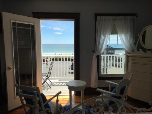a living room with a view of the beach at The Rebekah Inn in Old Orchard Beach