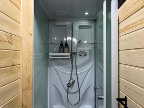 a shower in a bathroom with a glass door at みんとん家 in Takamatsu