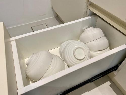 a group of white bowls and plates in a drawer at The Podium-Studio-Free 1 Parking-6 Pax-D335B in Kuching