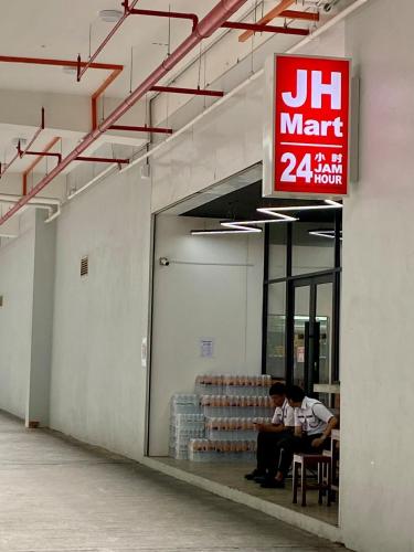 two men sitting inside of a building with a sign at The Podium-Studio-Free 1 Parking-6 Pax-D335B in Kuching