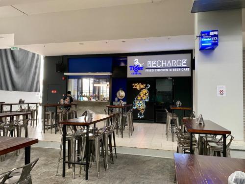 a restaurant with tables and chairs in front of a restaurant at The Podium-Studio-Free 1 Parking-6 Pax-D335B in Kuching