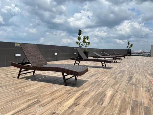 a row of chairs sitting on top of a roof at The Podium-Studio-Free 1 Parking-6 Pax-D335B in Kuching