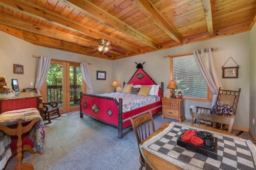 a bedroom with a bed and a table in a room at A Mountain Dream in Rocky Grove