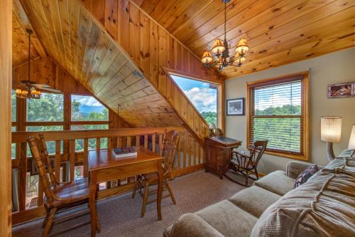 a living room with a staircase and a desk at A Mountain Dream in Rocky Grove