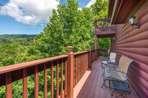 a deck with two chairs and benches on it at A Mountain Dream in Rocky Grove