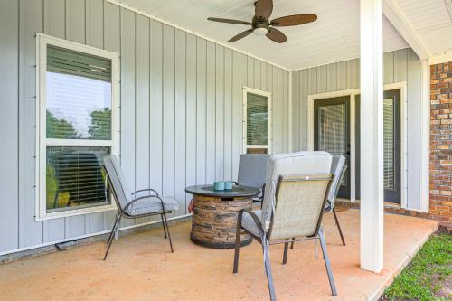 a patio with two chairs and a table and a ceiling fan at Suburban Bliss! Cozy Home with Neighborhood Perks in Theodore