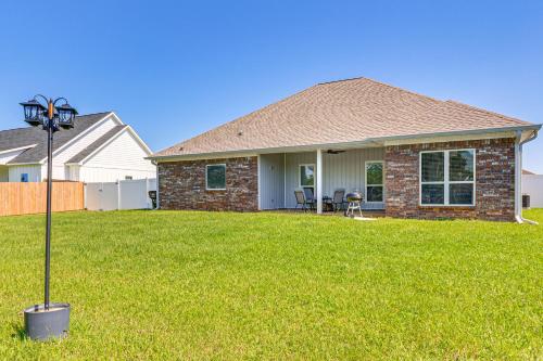 a house with a lamp in the yard at Suburban Bliss! Cozy Home with Neighborhood Perks in Theodore