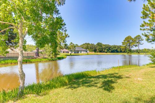 a view of a river with a house in the background at Suburban Bliss! Cozy Home with Neighborhood Perks in Theodore