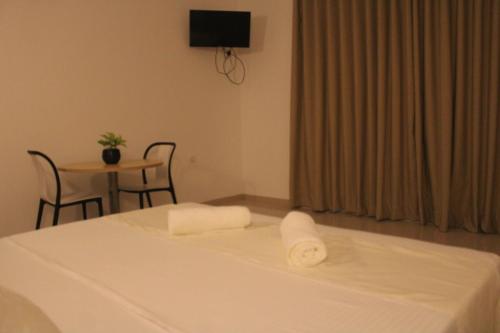 a hotel room with a bed with a towel on it at Exin River Breeze Transit Hotel - Katunayake in Dandugama