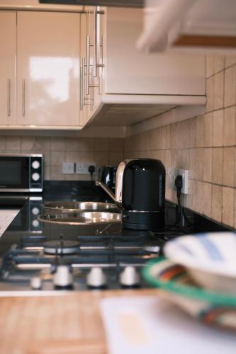 a kitchen with a stove top in a kitchen at Oxford Nest - Spacious & Luxury Apartments in Oxford