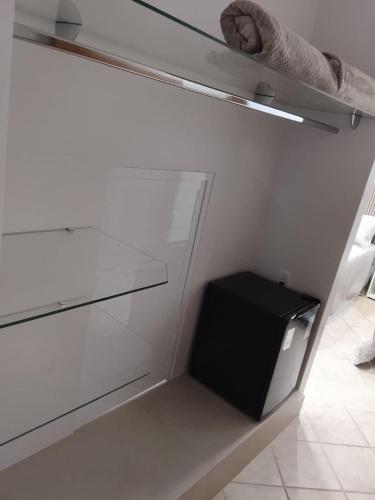 a empty closet with a drawer and a black box at Pindorama Golden Plaza Hotel - Pindorama SP in Catanduva