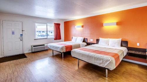 a hotel room with two beds and a window at Manteca, CA in Manteca