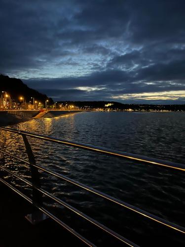 a view of the water at night from a boat at Oyster Cottage in The Mumbles