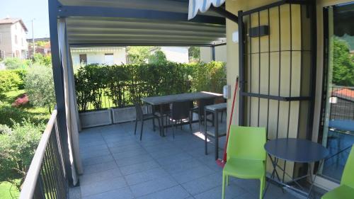 a patio with a table and chairs on a balcony at i laghi di Como in Erba