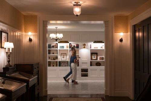 a woman is walking through a hallway at Omni Bedford Springs Resort & Spa in Bedford