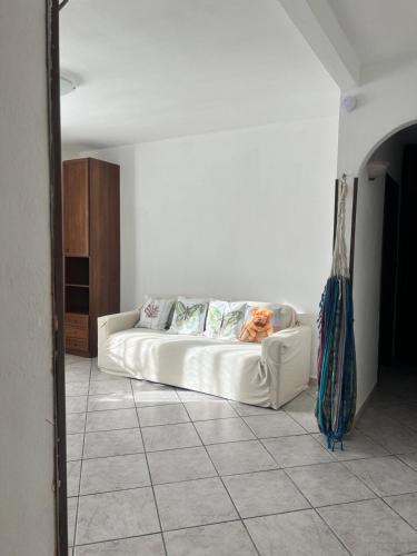 a living room with a white couch in a room at Gina&armando in Cassano Spinola