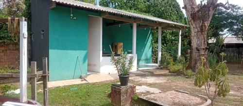a blue house with a potted plant in front of it at Rancho PÔR do Sol in Benevides