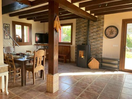 a kitchen and dining room with a table and a fireplace at Txatonea 