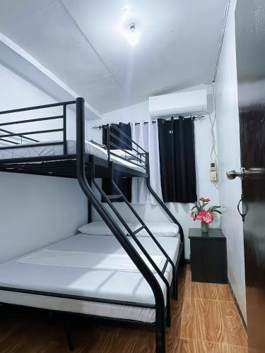 a couple of bunk beds in a room at AB Pam Staycation Gensan up to 20 pax in Lagao III