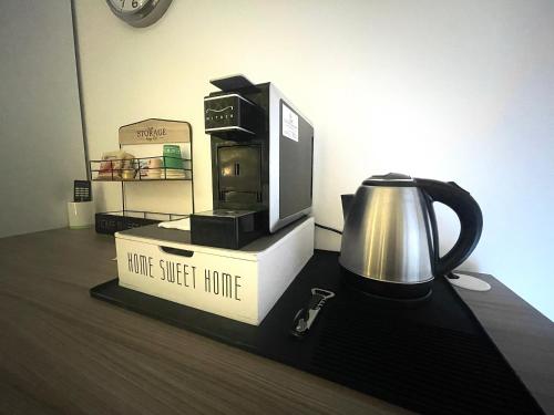 a counter with a coffee maker and a tea kettle at B&B CORSO ROMA Room Suite & Spa in Apricena