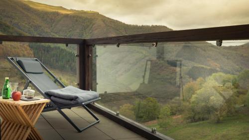 a balcony with a chair and a view of a mountain at Arantza Hotela - Boutique Hotel "Adults Only" in Arantza