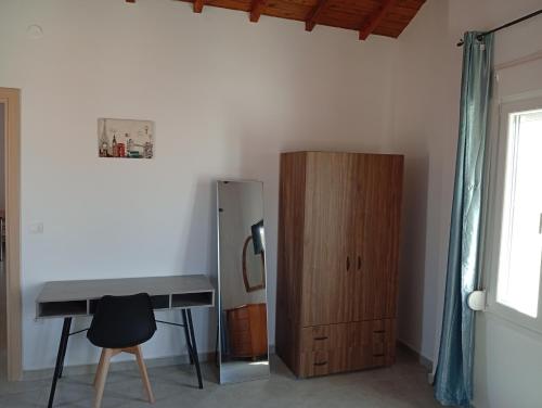 a desk and a wooden cabinet in a room at Tourni Cozy Chios in Chios