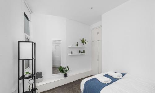 a white bedroom with a bed and a window at Steeple View Apartment - Cosy 1 bed in Montrose in Montrose
