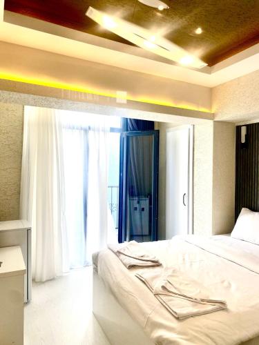 a bedroom with a large bed and a window at Taç hotel in Istanbul
