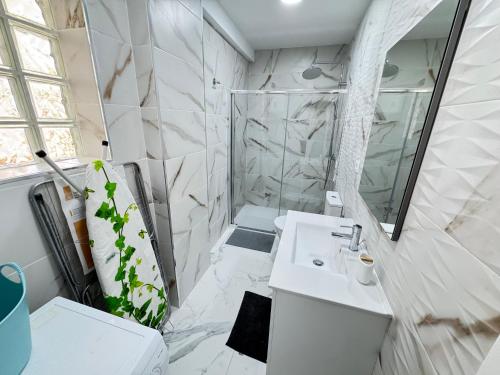 a white bathroom with a sink and a shower at Cozy Apartment with Wi-Fi in Costa de Adeje