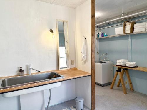 a bathroom with a sink and a mirror at 山二 -Yamafu in Imizu