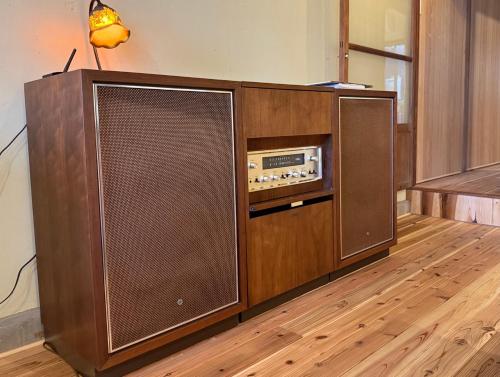 a large wooden entertainment center with a radio at 山二 -Yamafu in Imizu