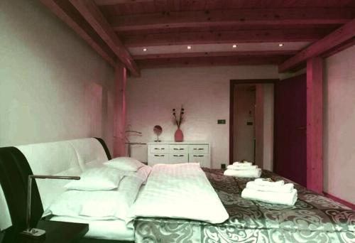 a bedroom with a large bed with white sheets at Modern 3 Bedrooms in Osijek in Osijek
