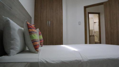 a bedroom with a bed with two pillows at D-rio Apto in Ríohacha