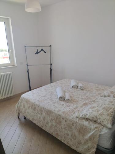 a bedroom with a bed with towels on it at Charme House Trulli, Bari, Polignano, Monopoli 5 star in Turi