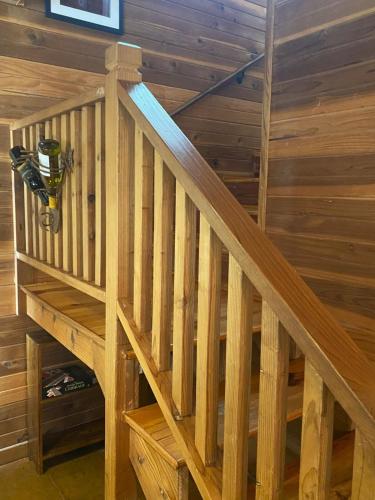 an overhead view of a wooden staircase in a log cabin at Private cabin on 100 scenic acres with balcony views in Pipe Creek