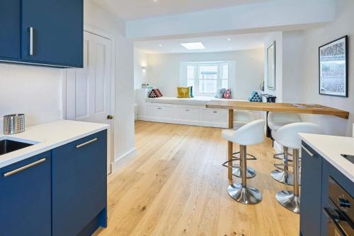 a kitchen with blue cabinets and white counter tops at Host & Stay - Window on the World in Brighton & Hove