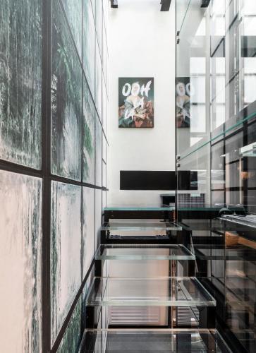 a staircase in a building with a glass wall at Dimora San Nicola Charming Suite in Conversano