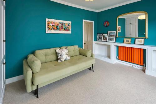 a living room with a couch and a mirror at Host & Stay - Window on the World in Brighton & Hove