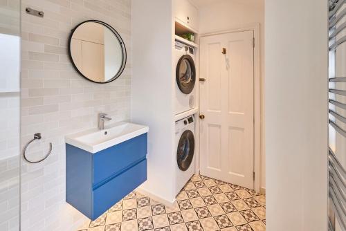 a bathroom with a sink and a washing machine at Host & Stay - Window on the World in Brighton & Hove